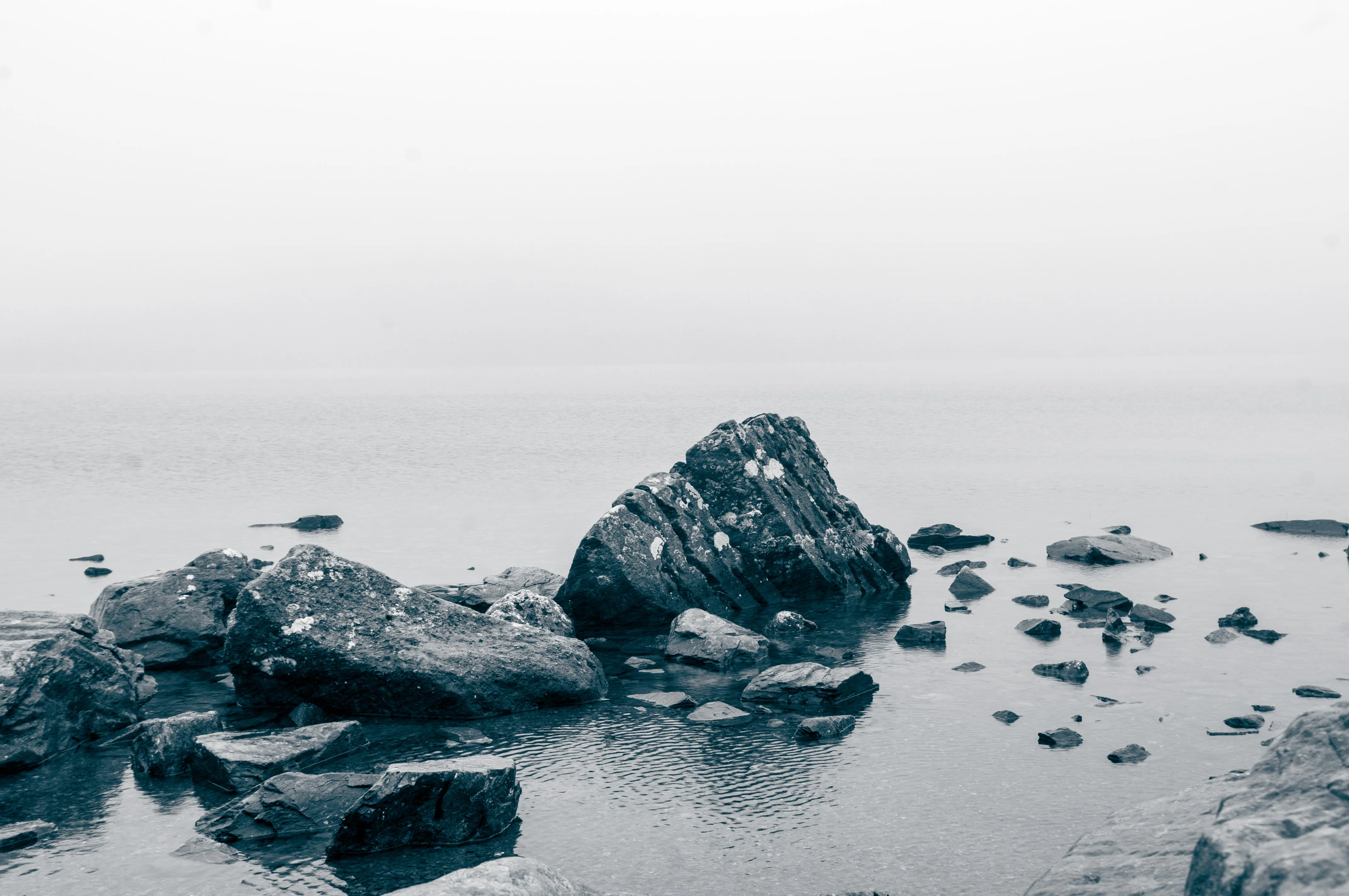 Some rocks in a misty lake