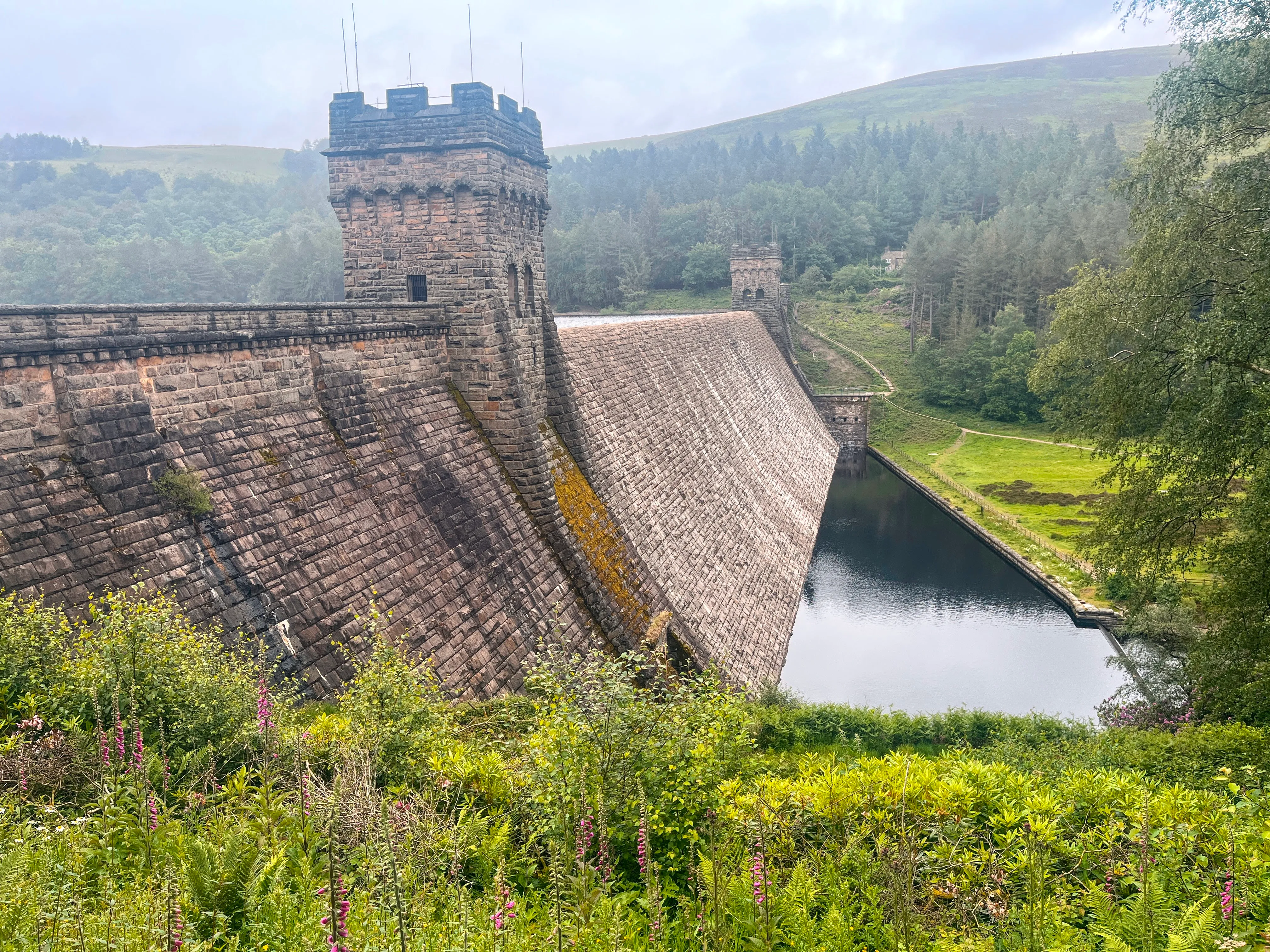 A photo of a Dam with pool in front of it