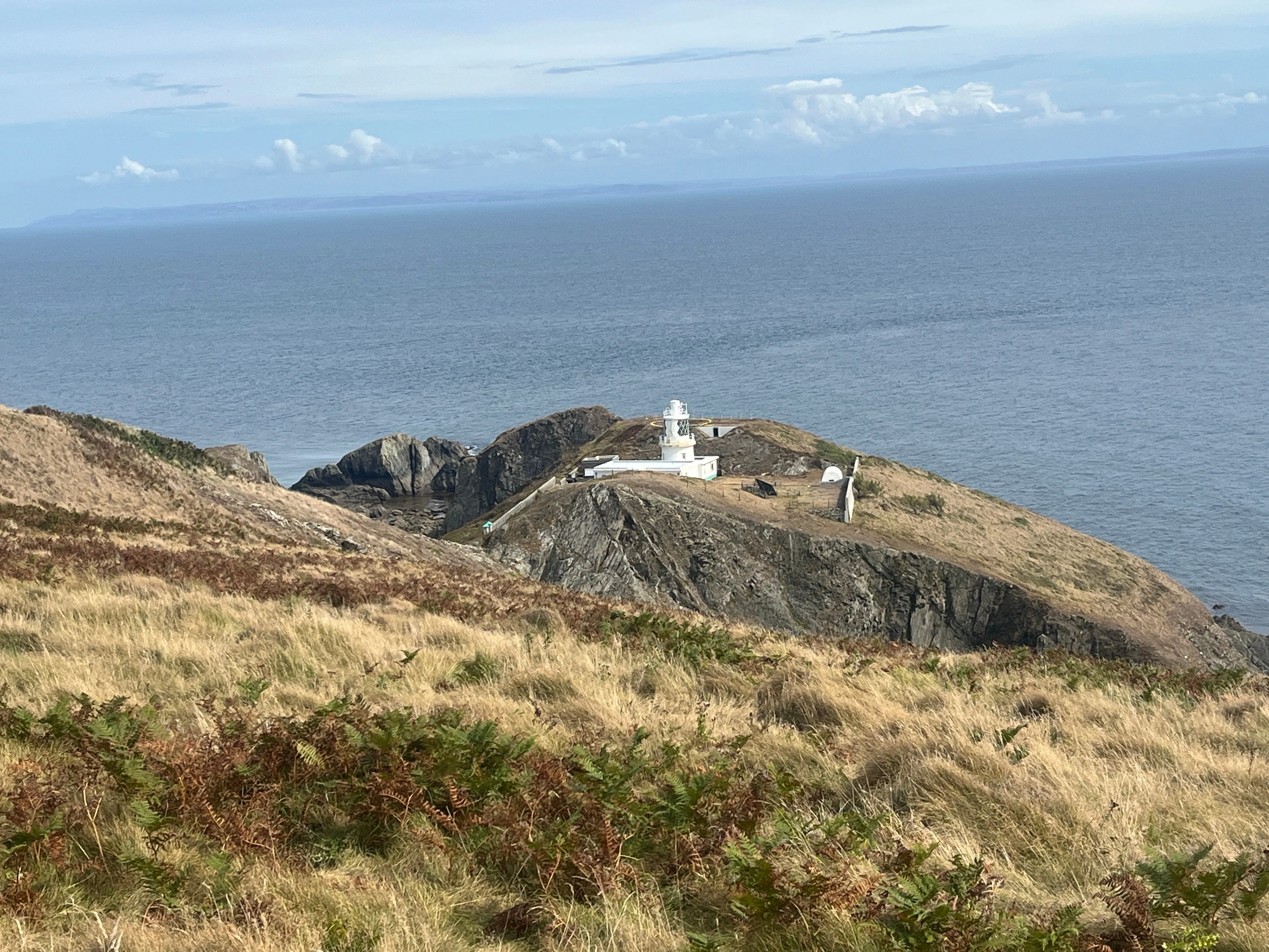 A modern lighthouse with a clear view of the sea.